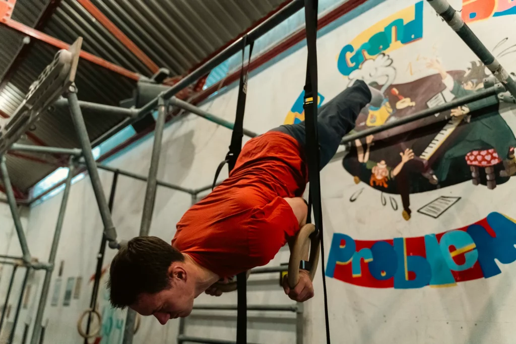 Performing a shoulder stand on gymnastics rings at a climbing gym Boulder Shack in Southampton